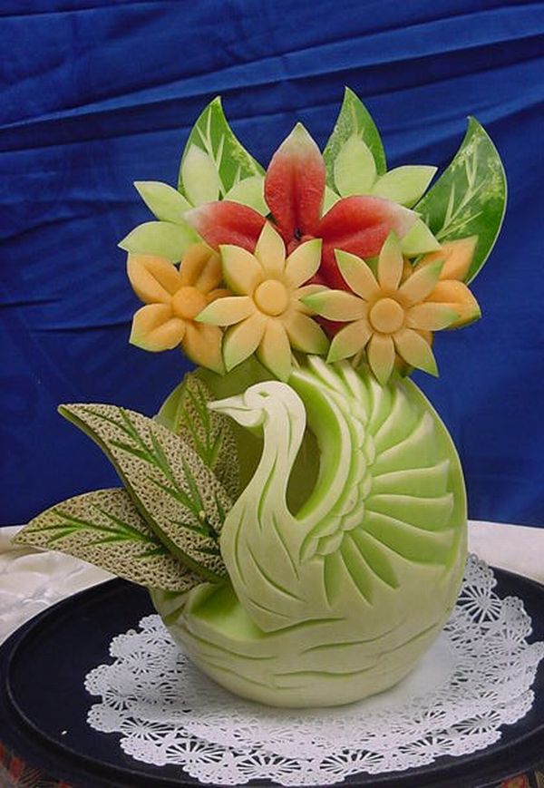 honeydew melon swan sculpture with fruit flowers