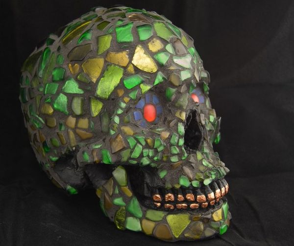 mosaic human skull made with green recycled glass 