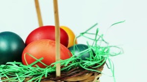 stock-footage-easter-eggs-background-colorful-easter-eggs-in-a-basket-with-green-grass-decoration-white
