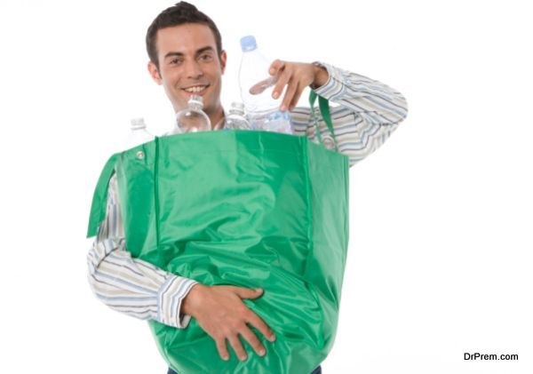 Young man holding a bag of plastic bottles for recycling