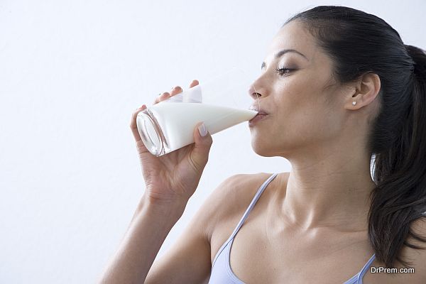 Close-up of a young woman drinking a glass of milk
