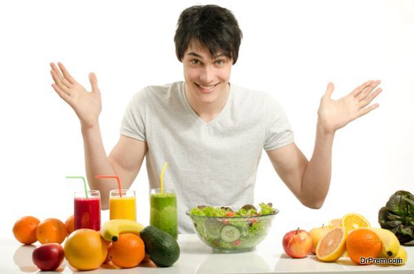 Man having a table full of organic food,juices, smoothie