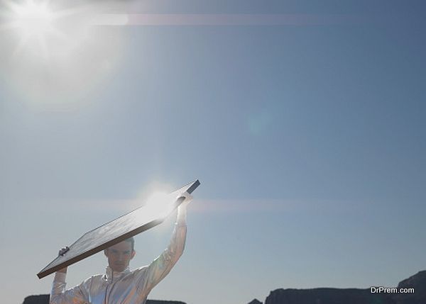 Young man with solar panel, portrait