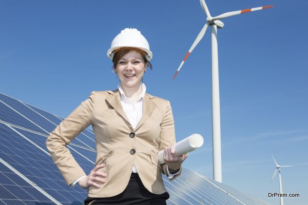 architect or engineer posing at solar panels in wind farm