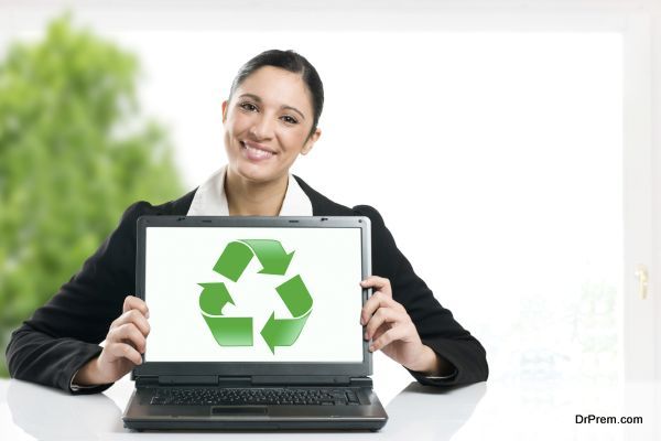 Business woman showing recycling green symbol in her laptop monitor, copy space for your text