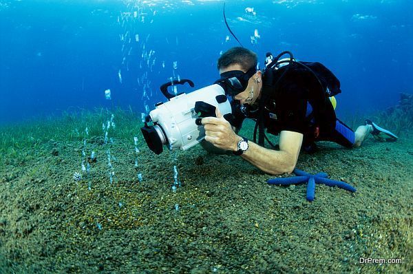 Scuba diver taking a photograph underwater