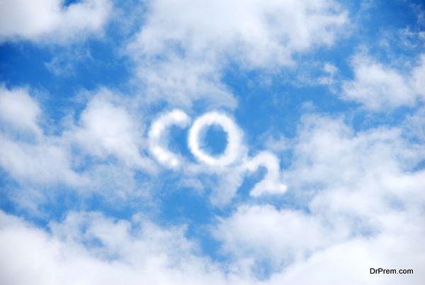 A cloud of white vapour forming the letters CO2 on a blue sky.