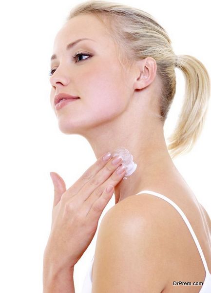 woman applying moisturizer cream on her neck