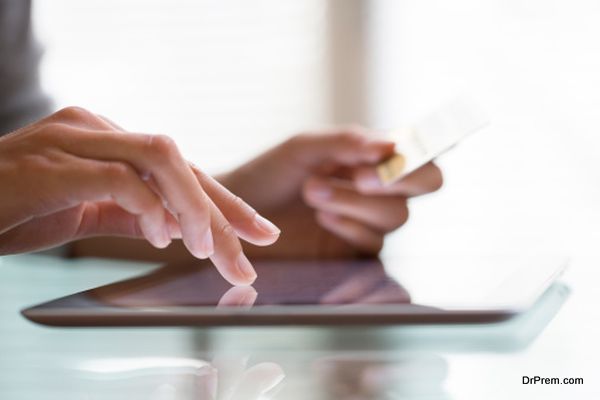 Woman shopping using tablet pc and credit card