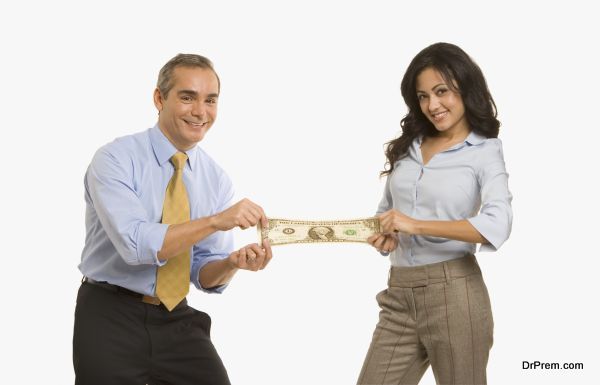 Businesspeople stretching a dollar between them