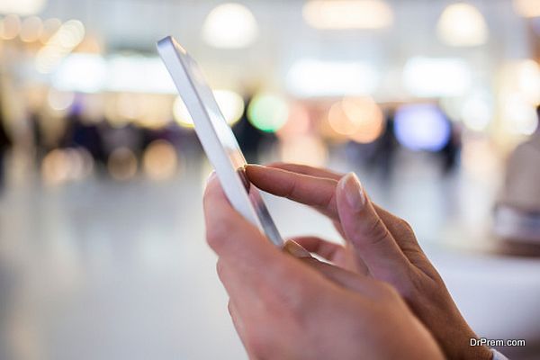 Woman sending messages with her mobile phone