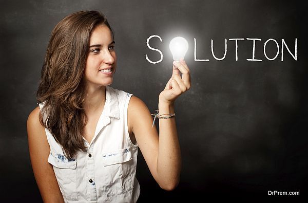 young woman holding a lightbulb composing solution word