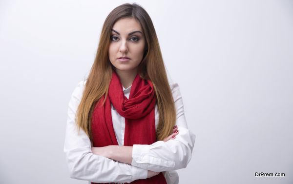 Portrait of a young woman with arms folded looking at camera