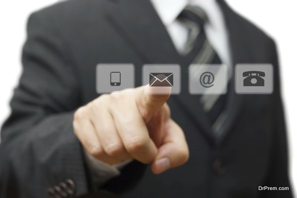 Businessman pressing virtual ( mail,phone,email ) buttons. cutomer support concept