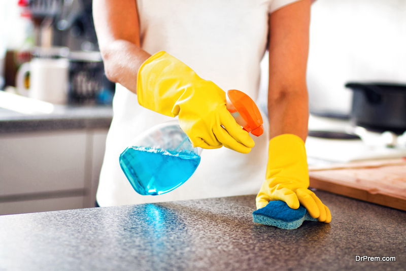 Woman-Using-Spray-Polish-To-Clean-Kitchen-Surface